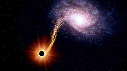 Obří černá díra pohlcující materiál hostitelské galaxie